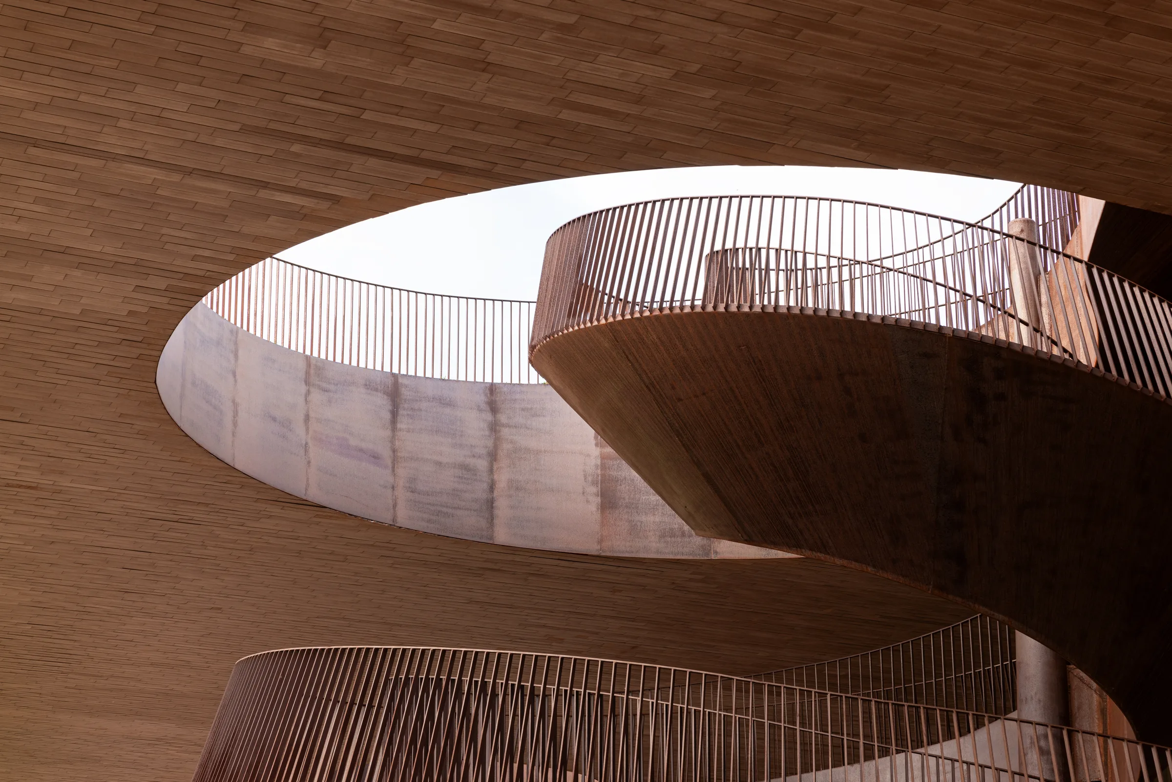 Looking up through the oval skylight at Cantina Antinori's spiraling staircase levels, Tuscany, by ARCHTRAITS
