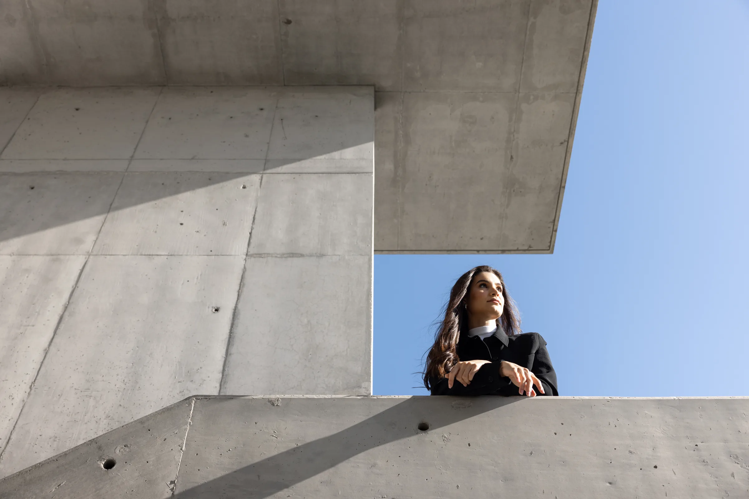 Multiple-exposure composite of a woman descending a concrete staircase in sequential positions at Miami Dade College, Florida, by ARCHTRAITS